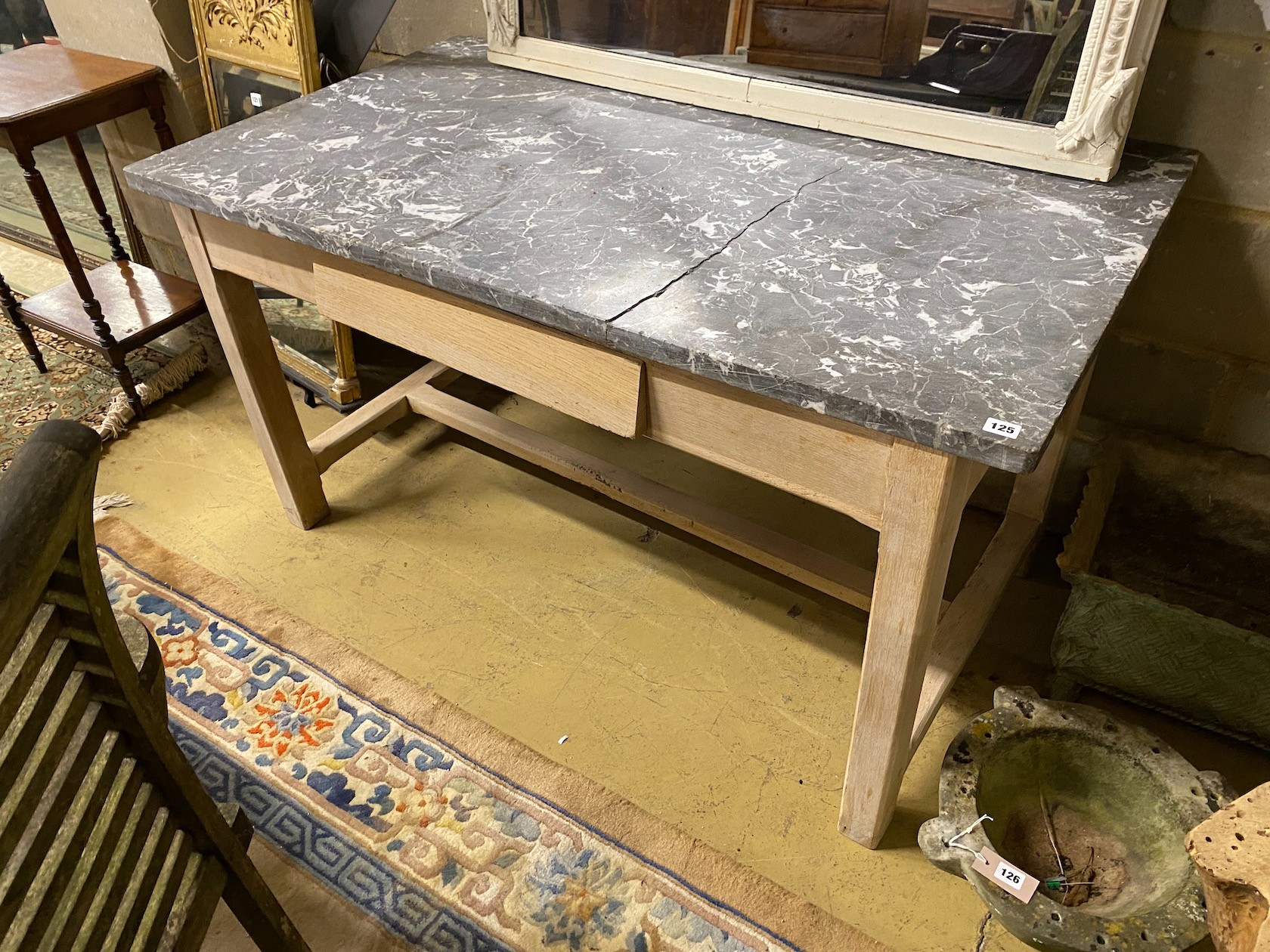 A bleached oak rectangular marble topped kitchen table, width 140cm, depth 80cm, height 77cm (marble damaged)